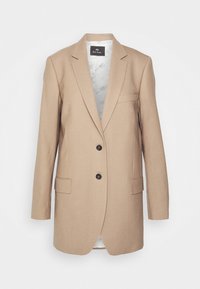 Blazer beige cintré avec deux boutons, revers crantés, et deux poches avant, doté d’une doublure lisse à l’intérieur.
