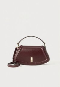 Burgundy leather handbag with a structured design, top handle, and detachable shoulder strap. Notable gold hardware accent.
