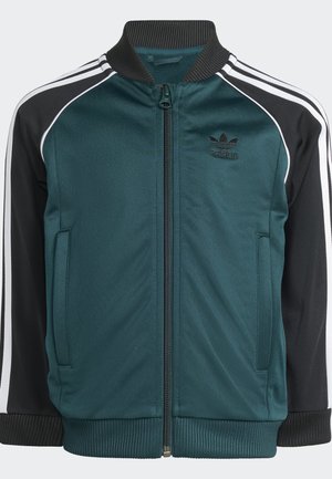 Mėlynas ir juodas Adidas džemperis su užtrauktuku, įrengta apykakle, baltais raštais ant pečių ir šoninėmis kišenėmis. Tekstūruotas audinio detalė.