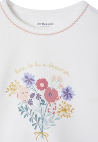 White cotton sweatshirt featuring a floral design with pink, purple, and yellow flowers, and gold text stating "born to be a dreamer."