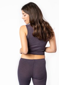Dunkelviolette Sporttanktop und Leggings in einem taillierten Design, aus einem weichen, strukturierten Stoff gefertigt. Verfügt über einen hohen Ausschnitt und eine cropped Länge.