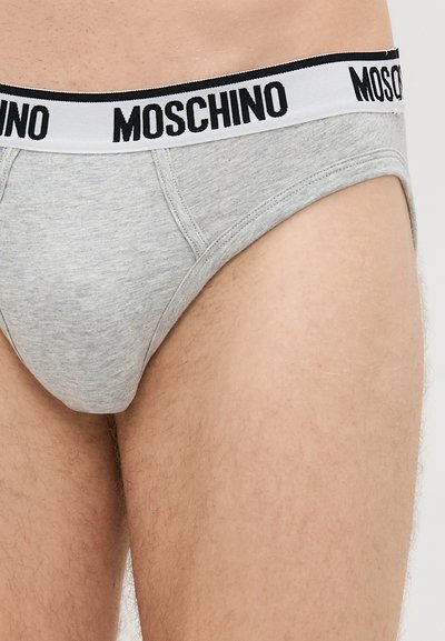 Hall mõõdus hall puuvillane aluspüks, millel on must-valge "MOSCHINO" elastne vöö. Omab tihedat sobivust ja sileda tekstuuri. Ei sisalda lisamustreid ega aktsente.