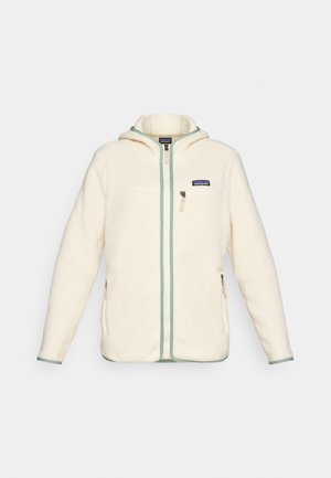 Nedidelis, balto pliušinio audinio džemperis su užtrauktuku priekyje, kapišonu ir mėtos žalios spalvos apdaila. Papildytas kairėje krūtinės pusėje esančia kišenė ir rankų kišenėmis. Minkšta tekstūra.