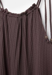 Ribbed, dark mauve top with a gathered neckline and adjustable straps, featuring soft texture and a relaxed fit design.