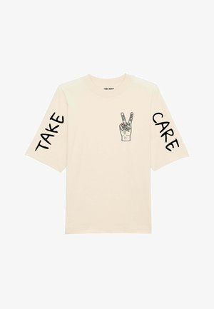 Beige cotton t-shirt with short sleeves. Front features a hand gesture graphic with "LOVE," "PEACE," and "CERTAINTY." Sleeves have "TAKE" and "CARE" text.