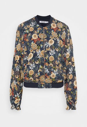 Veste bomber bleu marine avec fermeture éclair, ornée de motifs floraux beige, orange et blanc, avec col, poignets et ourlet côtelés.