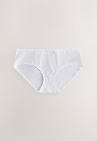 Culottes blanches en coton pour femmes avec un petit nœud sur la ceinture, posées à plat sur un fond beige.