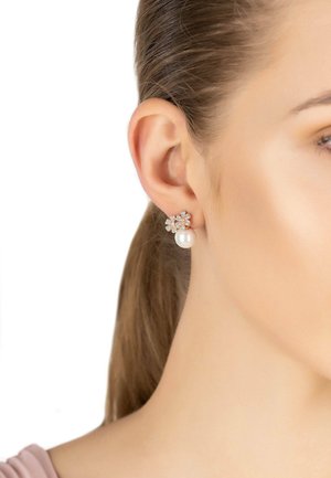 Pearl and crystal flower earrings with a pearl drop, featuring a silver-tone accent. Elegant design highlights sparkling crystals.