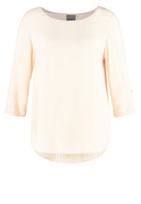 Haut à manches longues couleur crème clair avec un col rond, en tissu doux, et un ourlet arrondi. Design simple sans motifs ni accents notables.