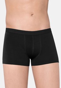 Boxers noirs en tissu doux avec une taille lisse. Présentent un design ajusté et des surpiqûres contrastées le long des coutures.