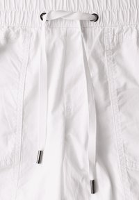 Witte lichtgewicht shorts met een elastische tailleband en een koord. Bevat zilveren hardware-accenten aan de uiteinden van het koord.