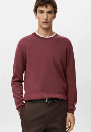Pull-over bordeaux avec un col rond, manches longues et poignets côtelés. Texture lisse, assorti à un pantalon marron foncé et une ceinture noire.