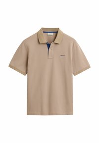 Polo beige avec un col intérieur bleu contrastant, manches courtes et petit logo brodé sur la poitrine. Matière en coton.