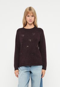 Dark burgundy sweater with a textured finish, featuring shiny heart-shaped sequins scattered across the front, round neckline, and long sleeves.