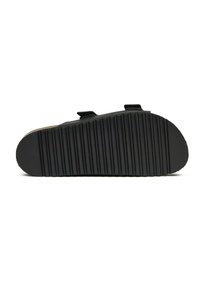Black slip-on shoe with a ridged rubber sole, featuring adjustable straps and a smooth upper surface. Sole design provides traction.