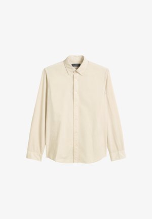 Lichtbeige knoopshirt met een kraag, lange mouwen en een rechte zoom. Gemaakt van textuurstof met subtiele naden en een label.