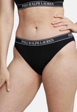 Melna bikini apakša ar baltu logotipa joslu. Izgatavota no mīksta, elastīga auduma ar gludu tekstūru un minimālu pārklājuma dizainu.