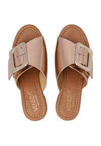 Bronzen leren sandalen met een brede strap en een grote zilveren gespaccent. Zachte bruine inlegzool met contrasterende stikdetails.
