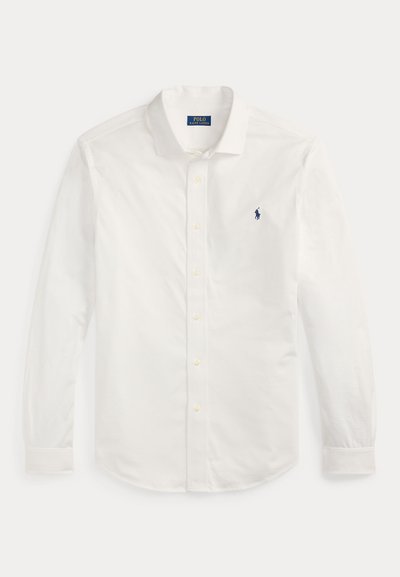 Valge pika varrukaga nööbitav särk kraega ja vasakul rinnal väike tumesinine Polo Ralph Lauren logo.