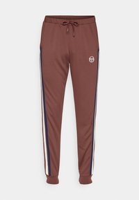 Bruna joggers med dragsko i midjan, med vita och marinblå sidostripes och en logotyp på låret. Tillverkade av ett mjukt, elastiskt material.