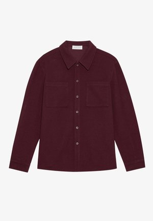 Burgundy button-up shirt made from soft fabric, featuring a classic collar, long sleeves, and two chest pockets with flap closures.