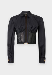 Μαύρο κοντό τοπ με μακριά μανίκια, χρυστό φερμουάρ μπροστά, γιακά, λεπτομέρειες με σούρα στο στήθος και διάφανα τμήματα από δίχτυ στην περιοχή της κοιλιάς.