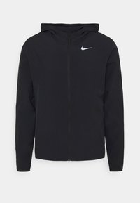 Schwarze Zip-Jacke mit Kapuze, aus glattem Material. Verfügt über ein kleines weißes Nike-Logo auf der oberen linken Brustseite.
