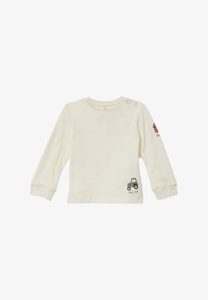 Crème katoenen shirt met lange mouwen, voorzien van een tractorafbeelding en de tekst "TRACTOR" op de voorkant, met drukknoopjes op de schouders voor gemakkelijk aan- en uittrekken.