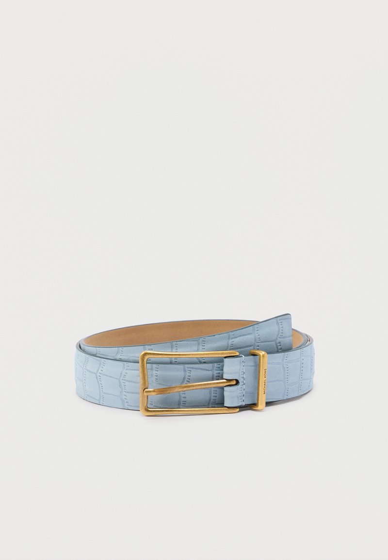 Ceinture en cuir bleu clair avec texture crocodile et boucle rectangulaire dorée, enroulée sur un fond blanc uni.