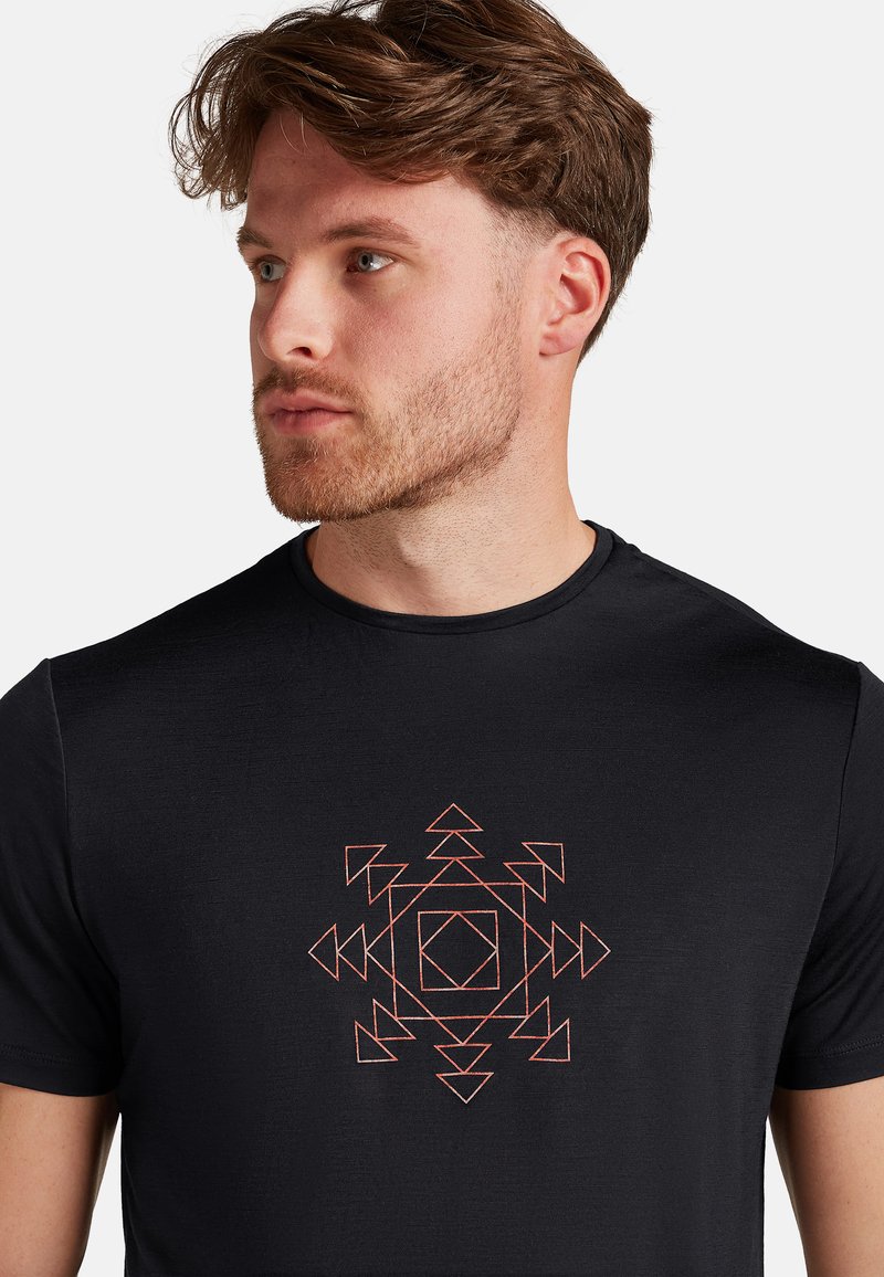Black t-shirt featuring a geometric design in orange and white. Short sleeves, round neck, smooth texture, with a central patterned graphic.