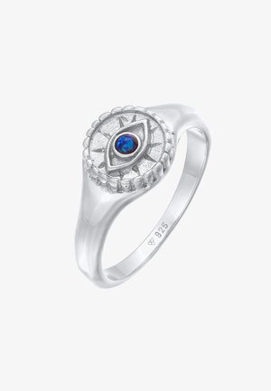 Bague en argent sterling avec un chaton circulaire présentant un motif en forme d'œil et une pierre précieuse ovale bleue centrale, poinçonnée 925 à l'intérieur de l'anneau.