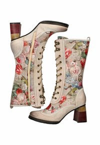Stivaletti alla caviglia color crema con motivo floreale, dotati di chiusura a zip e lacci decorativi. Il tacco a blocco impilato e multicolore offre un contrasto.