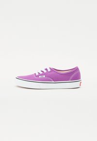 Purple canvas sneaker with white laces, black and white rubber sole, and a Vans logo on the side. Rounded toe and stitched accents.