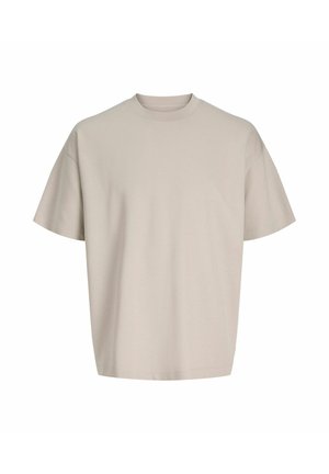 Beežist puuvillast lühikeste varrukatega T-särk, ümara kaelusega, lõdva lõike ja sileda tekstuuriga. Nähtavaid mustreid ega aksente ei ole.