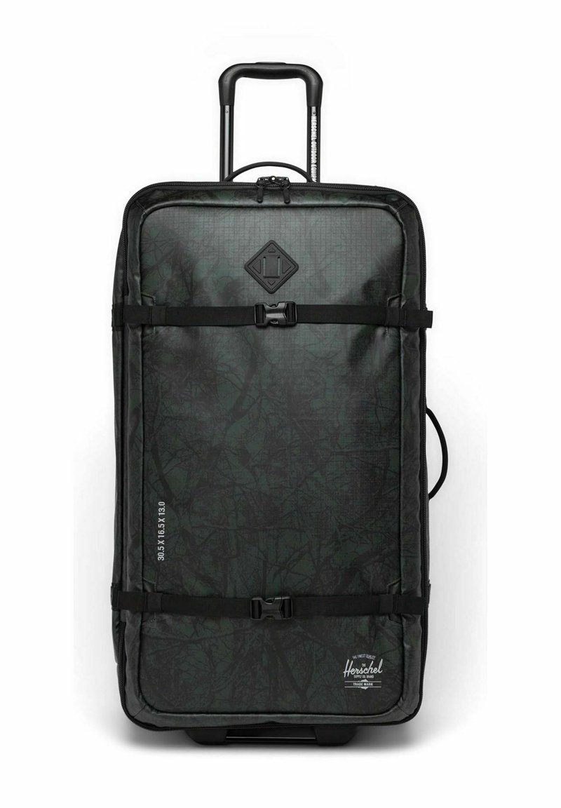 Valise à roulettes de couleur vert foncé avec une surface texturée. Équipée de sangles noires, d'un logo en forme de diamant et d'une poignée sur le côté. Dimensions sur le côté.