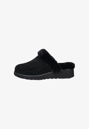 Black suede clogs with a faux fur collar, featuring a textured rubber sole and open back design for easy wear.