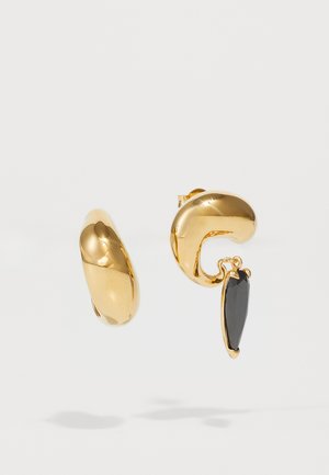 Gold-tone earrings featuring a smooth, rounded shape and a dangling black gemstone accent. The texture is shiny and polished.