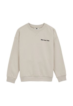 Sweat-shirt beige à col rond avec poignets et ourlet côtelés, comportant un texte noir "Ride the Vibe" sur le côté gauche de la poitrine.