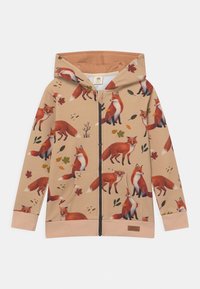 Beige zip-up hoodie med ett mönster av en räv och löv. Har en huva, framfickor och elastiska ärmslut. Tillverkad av mjukt tyg.