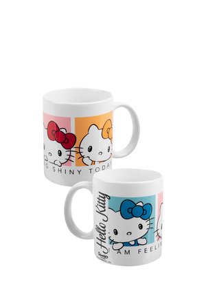 Tazze in ceramica bianca con volti Hello Kitty con fiocchi rosa, arancioni e blu e testo su sfondi quadrati colorati.