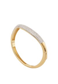 Gold-tone metal bangle with a curved design, featuring a row of sparkling clear stones along the top edge. Smooth, glossy finish.