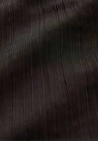 Black textured fabric featuring fine, vertical stripes. Smooth surface with a subtle sheen, creating depth in color and pattern.