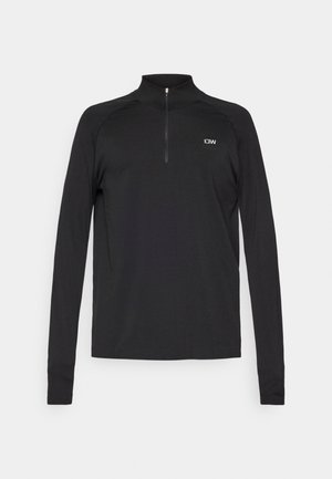 Top sportivo nero a manica lunga con collo alto, dotato di mezza cerniera e un piccolo logo sulla parte superiore del petto a sinistra. Tessuto dalla texture liscia.