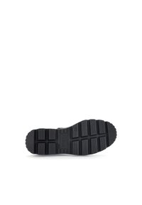 Black rubber sole featuring a textured pattern with rectangular and square indentations, providing grip and stability.