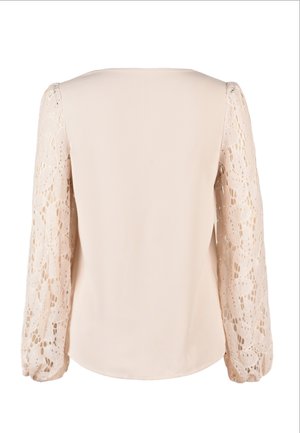 Blouse met een glad lijf van lichtroze stof en doorschijnende kanten lange mouwen met bloemmotieven en een geplooide manchetdetail.