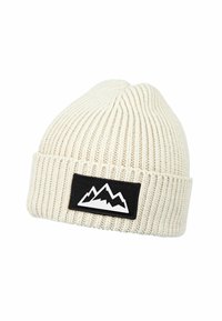 Cream-colored knit beanie with folded cuff featuring a black rectangular patch displaying a white mountain range design.