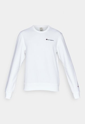 White crewneck sweatshirt made of cotton, featuring a small red and black "Champion" logo on the chest and ribbed cuffs and hem.