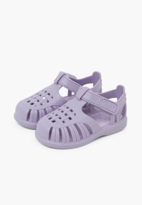 Purple rubber sandals with a woven design, open sides for ventilation, adjustable strap, and a sturdy sole for comfort and stability.