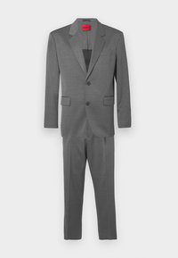 Hall, kaheosaline ülikond peene ruudumustriga. Üksrinnaline jakk sälklapiga ja kahe eesmise taskuga; kitsad püksid.