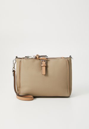 Beige nylon crossbody bag with leather accents, rectangular shape, top zipper closure, and an adjustable strap. Features a faux buckle detail.